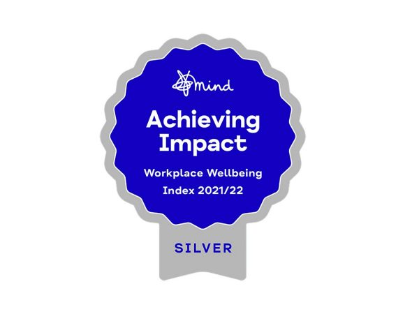 Mind silver badge with the Mind Logo against a blue background