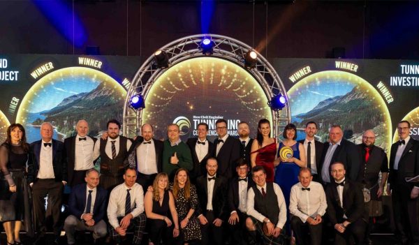 A group of people on a stage accepting the award