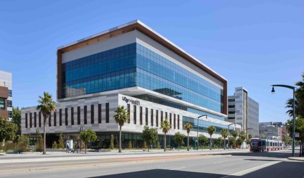 The exterior building from the street with traffic. Image credit: David Wakely